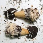 two ice cream cones with oreo cookies on them